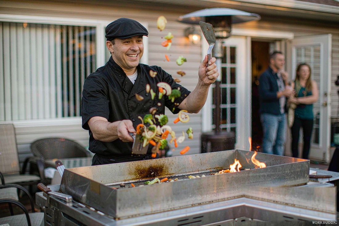 Private hibachi chef performing a teppanyaki flame show at an Orange County home