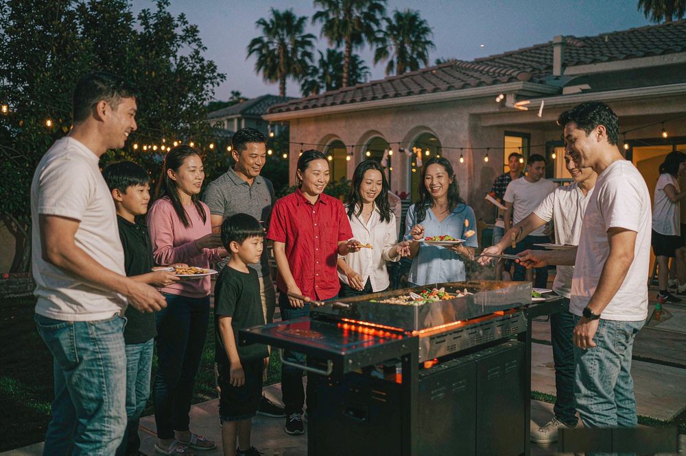 Guests enjoying a backyard hibachi party in Orange County
