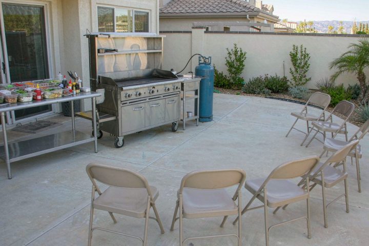 Mobile hibachi grill setup on a backyard patio showing the flat cooking zone and clearance needed